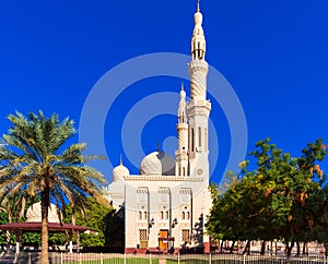View of the facade of the building of the mosque Jumeirah, Dubai, United Arab Emirates. Isolated on blue background