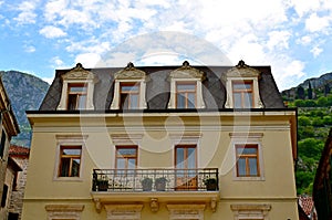 View of the facade of the house with a balcony and roof windows