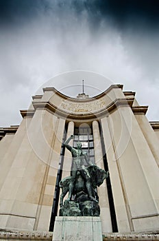 view of the facade with statue of the Theater National de Chaillot