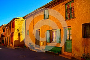 View on facade of typical yellow red houses against blue sky