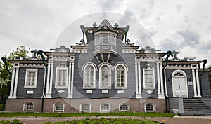 View of facade of wooden house of Decembrist Sergei Trubetskoy in Irkutsk in summer in cloudy weather