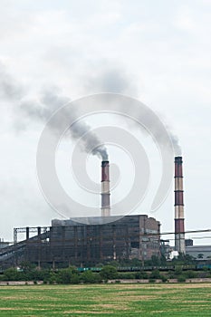 View of the factory in the city, smoke from the chimney. Air pollution, global warming