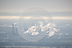 View of a factory and industrial zone through the fog and smog, the concept of air pollution