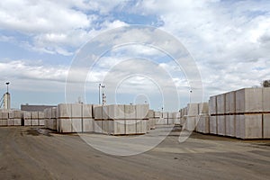 View of factory plant producing autoclaved aerated concrete. Packages of blocks on pallets put one on the other on an outdoor