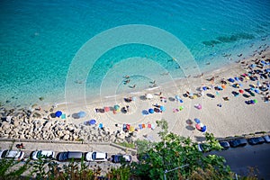 View of the famous beach with colourful umbrellas in Tropea Cal
