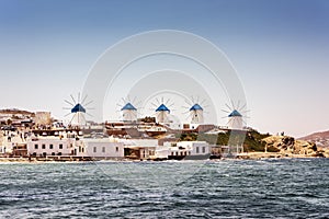 View of famous Mykonos island windmills and coastline on the Aegean sea.