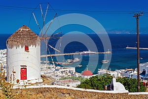 View of the famous Mykonos windmill above  port and Mykonos town