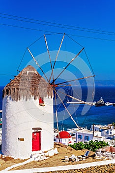 View of the famous Mykonos windmill above  port and Mykonos town