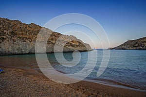 View of the famous rocky beach Melidoni in Kythira island at sunset. Amazing scenery with crystal clear water and a small rocky