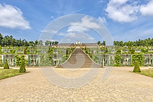 View of the famous stairs of the sanssouci palace in Potsdam Germany, background consists of a clear blue sky with white clouds