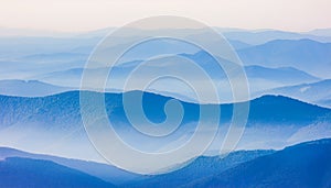 View of far away blue mountains in the fog photo