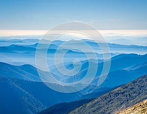 View of far away blue mountains in the fog photo