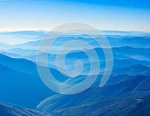 View of far away blue mountains in the fog photo