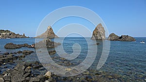 View of Faraglioni of Acitrezza. Rocks of the Cyclops, typical lava stacks. Sicily, Italy. Footage 4k