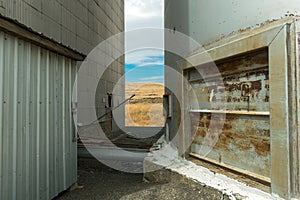 A View of a Farm Field Between Storage Bins at a Grain Elevator