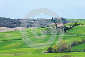 View of a farm upon the green hills of the Tuscany countryside,  Italy
