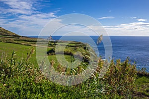 View of Farol da Ponta da Ferraria lighthouse from Miradouro da Ilha Sabrina, Sao Miguel Island, Azores, Portugal