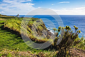 View of Farol da Ponta da Ferraria lighthouse from Miradouro da Ilha Sabrina, Sao Miguel Island, Azores, Portugal