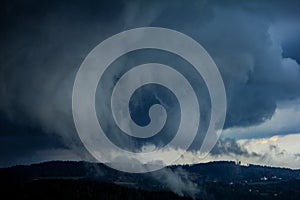 view of fast approaching clouds in the mountains during a hellish storm