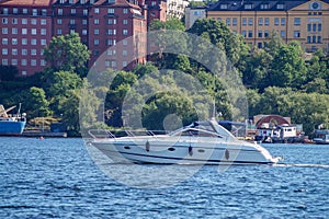 View of fast boat in sea next to city