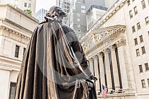 View from Federal Hall of the statue of George Washington and the Stock Exchange building in Wall Street, New York City.