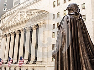 View from Federal Hall of the statue of George Washington and the Stock Exchange building in Wall Street, New York City.