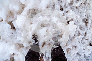 View of the feet drowning in the cold thick sea foam. White sea