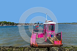 A view of a ferry docked at low tide on the River Hamble