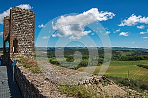 View of fields and hills of Tuscany from above the walls of the Monteriggioni hamlet.