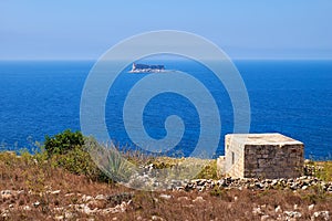 The view of Filfla islet with the guard building on the foreground.