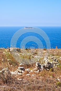 The view of Filfla islet with the part of Qrendi coast on the foreground. Malta