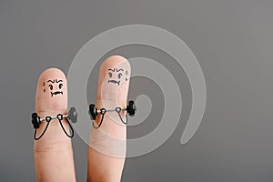 View of fingers as sportsmen training with barbells isolated on grey