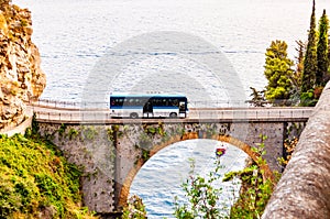 View on Fiordo di Furore arc bridge built between high rocky cliffs above the Tyrrhenian sea bay in Campania region. Bus driving