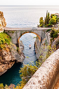 View on Fiordo di Furore arc bridge built between high rocky cliffs above the Tyrrhenian sea bay in Campania region. Car driving