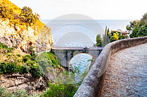 View on Fiordo di Furore arc bridge built between high rocky cliffs above the Tyrrhenian sea bay in Campania region. Curved