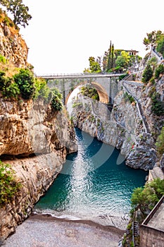 View on Fiordo di Furore arc bridge built between high rocky cliffs above the Tyrrhenian sea bay in Campania region. Unique cove