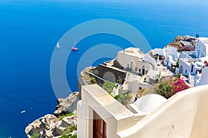 View of Fira town - Santorini island,Crete,Greece. White concrete staircases leading down to beautiful bay