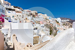 View of Fira town - Santorini island,Crete,Greece. White concrete staircases leading down to beautiful bay