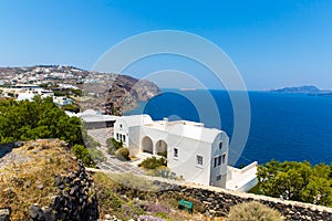 View of Fira town - Santorini island,Crete,Greece. White concrete staircases leading down to beautiful bay