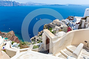 View of Fira town - Santorini island,Crete,Greece. White concrete staircases leading down to beautiful bay