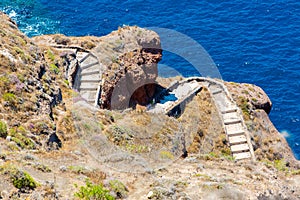 View of Fira town - Santorini island,Crete,Greece. White concrete staircases leading down to beautiful bay