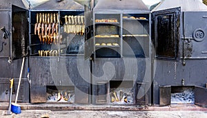 View of fish being smoked in large metal smokers