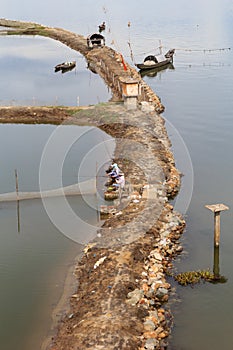 View of fisherman sit on the dikes photo