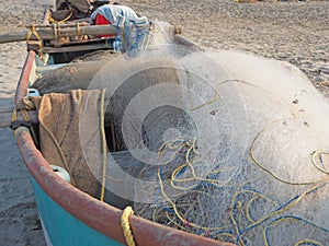 view of a fishing boat with a net loaded into it. The concept of fisheries