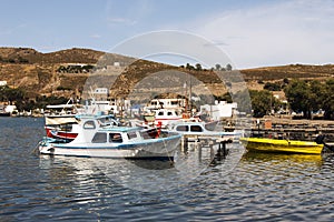 A view of fishing boats, motorboats in the seaside of the island Patmos, Greece in summer