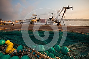 A view of a fishing net in front of the boat on the beach. Beautiful calm sea and water during an hot summer day