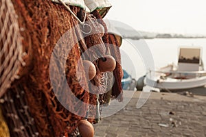 A view of a fishing net in front of the boat on the beach. Beautiful calm sea and water during an hot summer day