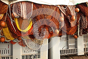 A view of a fishing net in front of the boat on the beach. Beautiful calm sea and water during an hot summer day