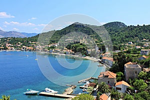View of the fishing port and the beach, with cafes, boats, in the village Lopud, Lopud Island, one of the Elaphiti Islands, view f