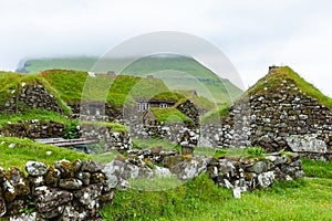 View of fishing village in Koltur island. Faroe Islands. Green roof houses. Nordic natural landscape